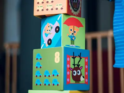 child stacking building blocks