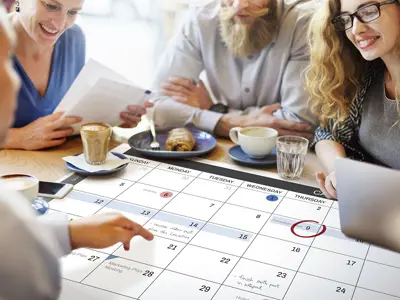 People gathered planning an event calendar