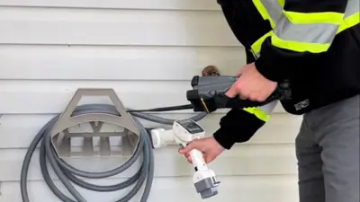 water meter check by employee garden hose reel