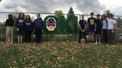 École St. Mary School kids with Oki fence sign 