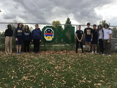 École St. Mary School kids with Oki fence sign 