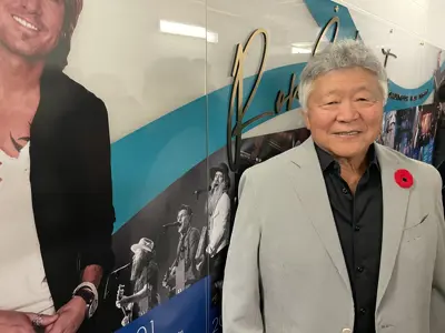 Ron Sakamoto beside Keith Urban poster