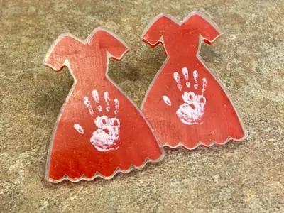 2 red dress pins on counter