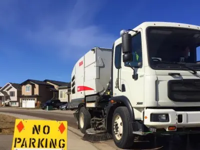 Street sweeper with no parking sign