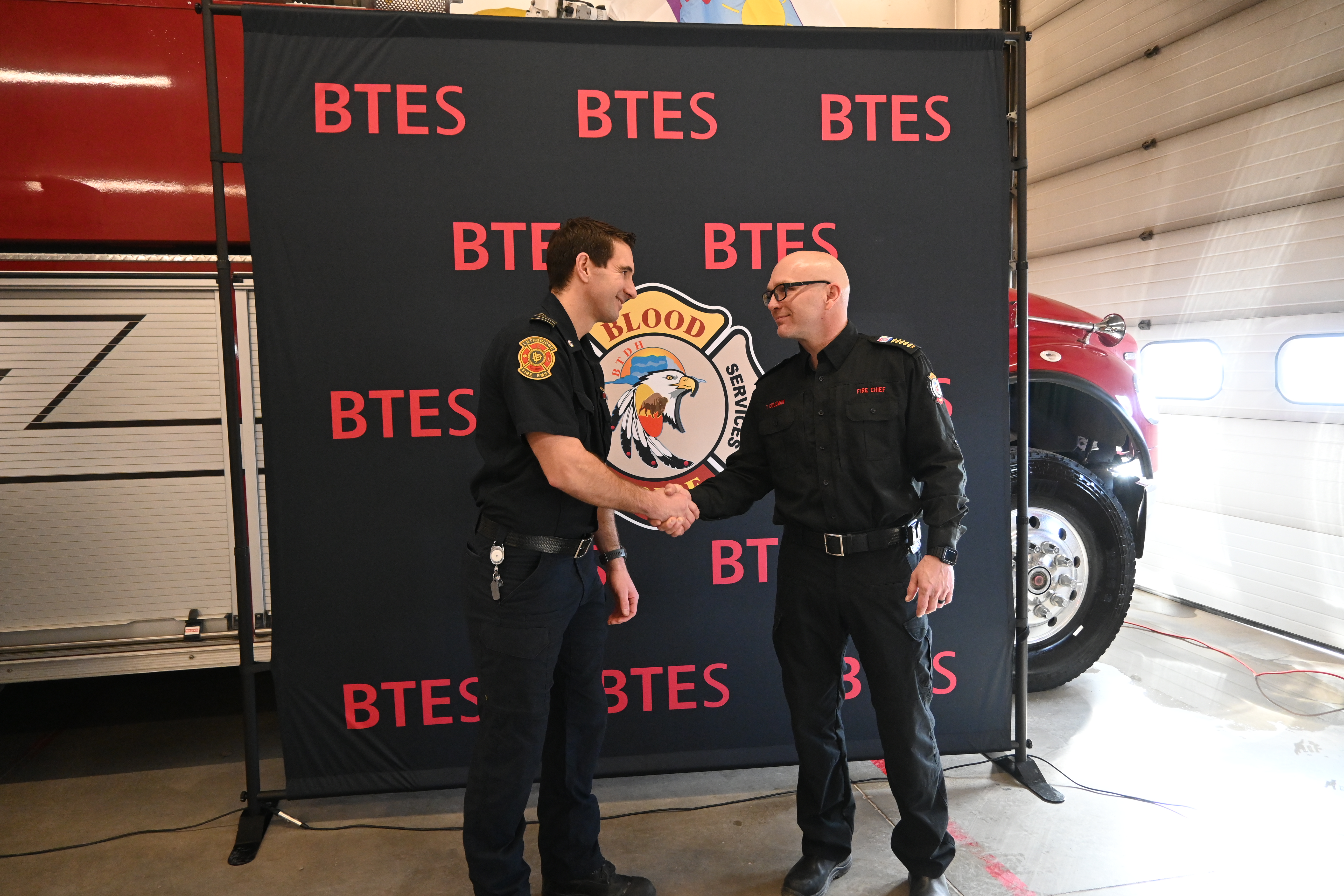 LFES DC McKeown and BT Chief Travis Coleman - shaking hands at announcement of fire dispatch - February 24, 2025